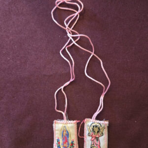 Embroidered fabric scapular. The front features a  image of Divino Niño, and the back features Our Lady of Guadalupe. Scapular badge measures 1.00 inches wide, 1.15 inches high. Scapular wire length: panel to panel: 17 inches. Escapulario de tela bordado  En la parte delantera muestra imagen del Divino Niño,  en la parte de atrás la Virgen de Guadalupe. Medidas de la insignia escapular 1.00 pulgadas ancho  de la insignia escapular, 1.15 pulgadas alto Longitud del cable escapular: panel a panel 17 pulgadas.